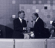 two men in suits shaking hands