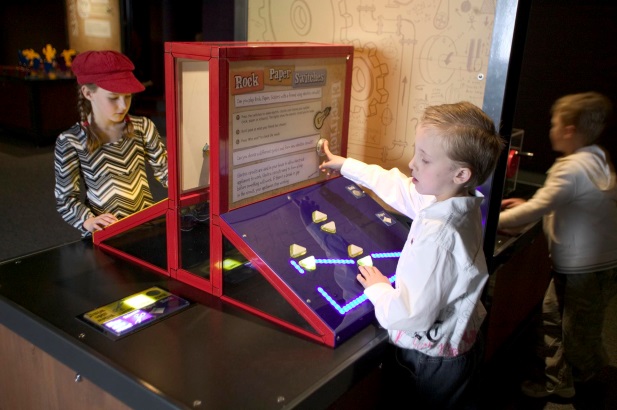 Two children looking at one of the Innovation Factory exhibits Two kids looking at a display on a table