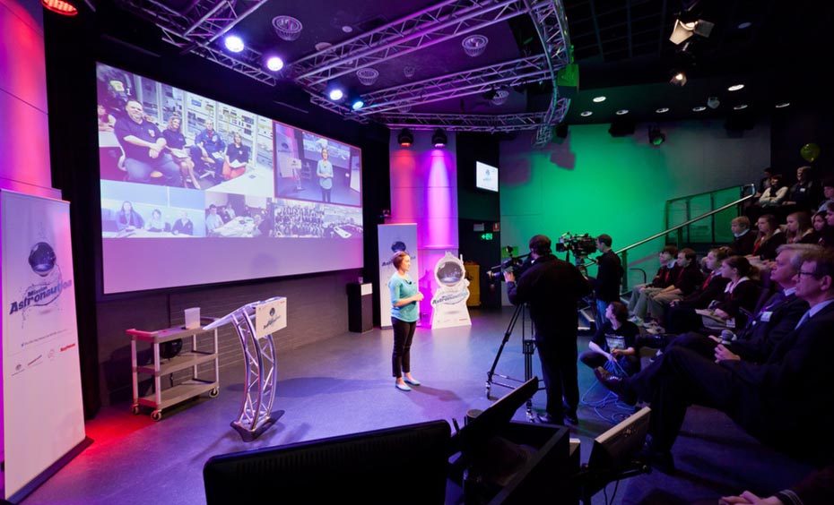 Photo of the Mission Astronautica videoconference, MC and audience in Questacon's Japan Threatre