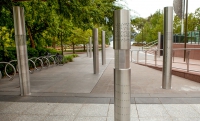 Hidden messages can be communicated using encryption or code. Eight stainless steel vertical poles about 2 metres in height are spaced apart and embedded into a concrete and paved garden area. On each of the poles are laser cut out cryptographic symbols.