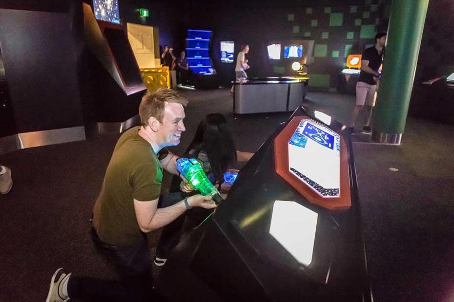 People playing laser tag in the Awesome Earth Gallery People playing laser tag in the Awesome Earth Gallery