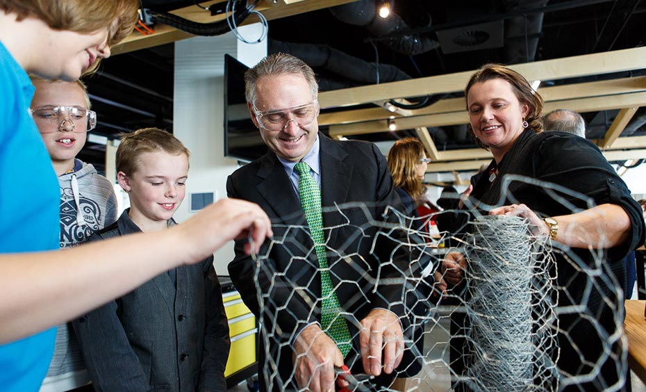 The QTLC programs will help young people harness their own creativity, giving them confidence to embark on the journey from idea to product. A man, two woman and two school children working with chickenwire.