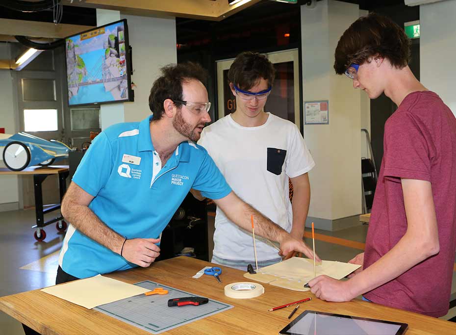 Questacon announces partnership with Samsung A Questacon staff member helps two teenage boys work on a model bridge.