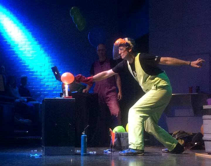Man touching balloon with man watching on