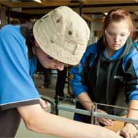 two teenage girls in a workshop