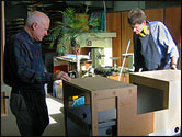 two men fabricating a timber exhibit