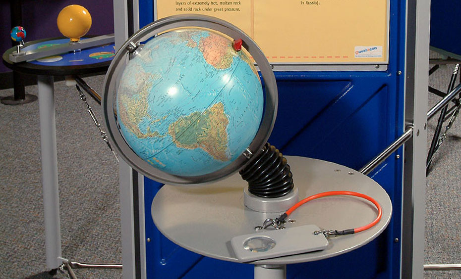 Move a pointer to any place on the globe and imagine digging through to the other side of the world. A model globe in front of a blue and yellow information panel.