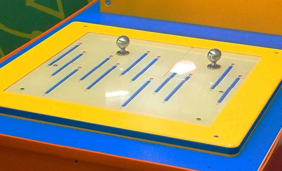 Count the number of pencils. Swap the panels and count the number of pencils again. On a yellow and blue flat surface there are two brushed metal knobs with pictures of muliple blue pencils.
