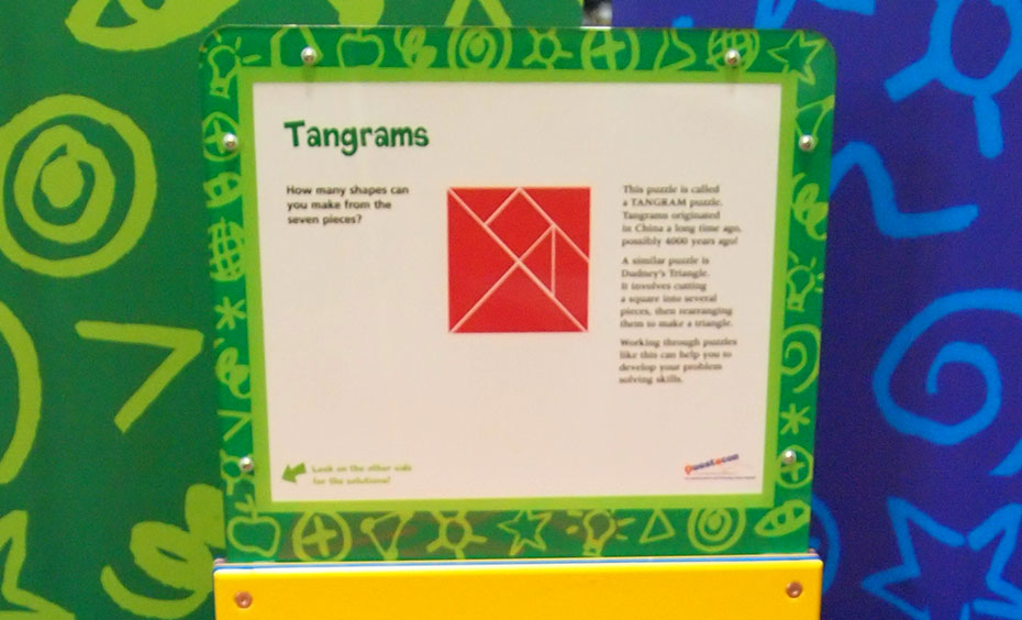 See how many shapes can be made from the same seven geometric puzzle pieces. A yellow, green, red and white information panel with the title 'Tangrams'. In the centre of the panel is a red square that is made up of different small shapes.