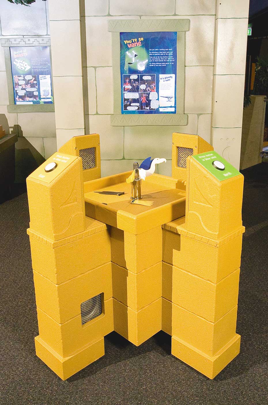 Wind direction is measured in the direction the wind is coming from. An unusually shaped yellow exhibit table, that has a button to press at each of the four corners and has a model bird in the centre.