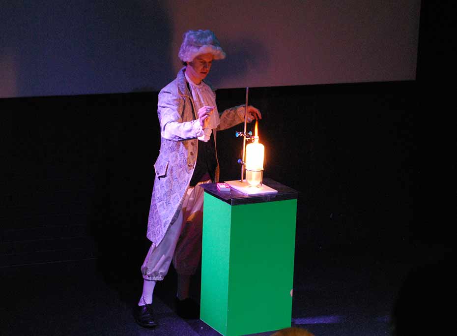 Burning oxygen during EuroScience at Questacon A man in 17th Century costume performs an experiment with fire.