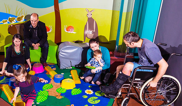 Small children playing while parents watch