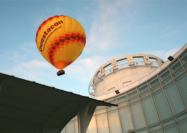 Questacon hot air balloon flying over the Questacon building.