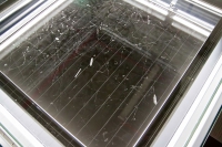 Photo showing detail of vapour trails in Cloud Chamber Photo showing cosmic rays as vapour trails passing through Cloud Chamber exhibit