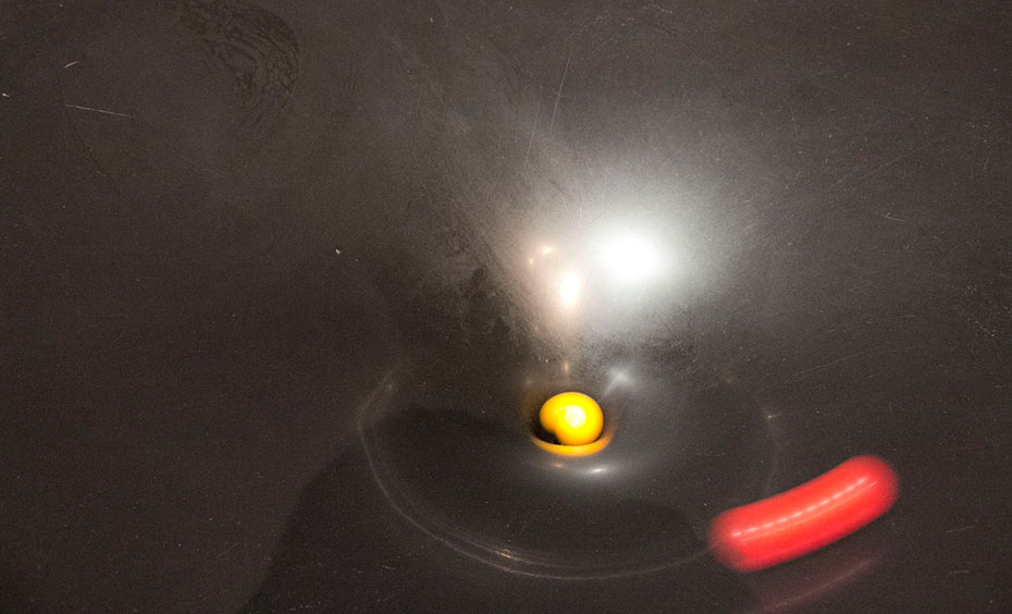 Release one or two balls into the funnel-shaped dish and watch the balls spin around the dish before it disappears down a hole a red and yellow ball rolling down into a gravity well