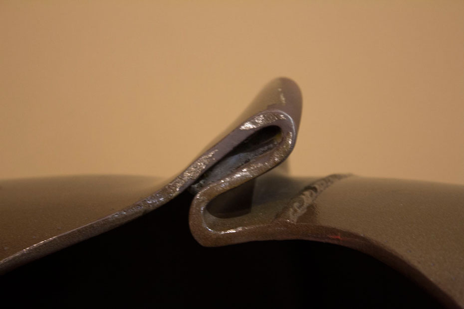 A section of damaged gas pipe shows the strength of a 6.6 magnitude earthquake. Close up of twisted metal from a large gas pipe.