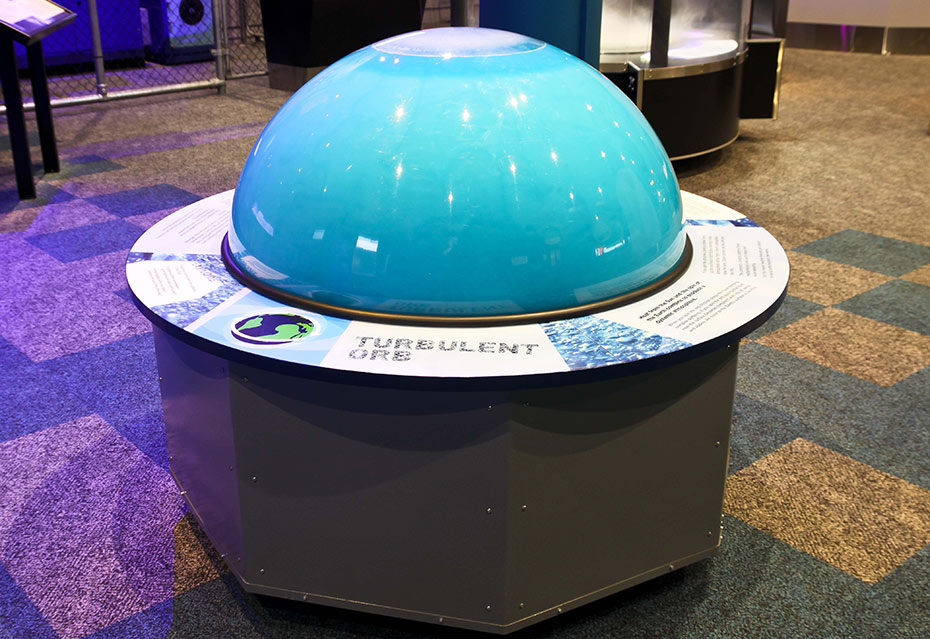 Spin a globe and watch fluid inside form random swirling patterns. A large blue orb exhibit.