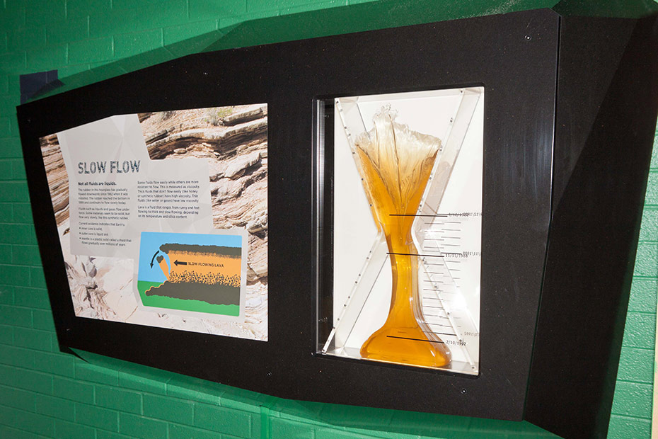 This synthetic rubber appears to be solid, but it behaves like a fluid. A large display case which has a perspex hour glass with a yellow synthetic rubber slowly flowing from top to bottom.
