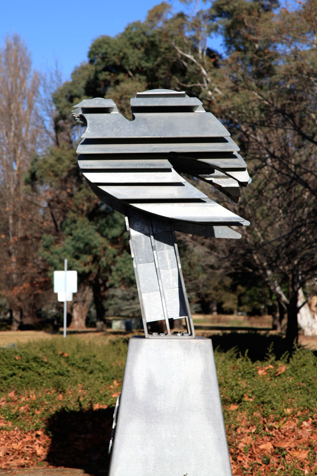 A three dimensional sculpture of Einstein's face reveals a second image when viewed from a different angle. A side on view of an Albert Einstein head and shoulders sculpture, where in this side view, the sculpture takes the shape of a dove.