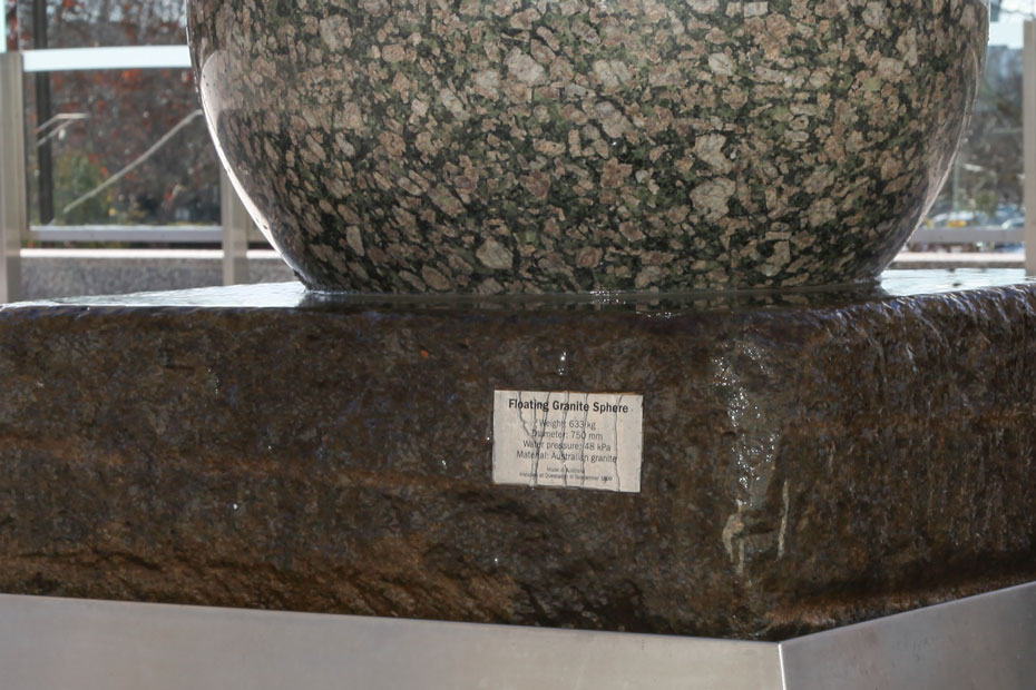 Hydraulic pressure and lubrication allows very large masses to be moved. A large granite stone ball sitting on a large slab of stone, which intern sits within a stainless steel bin. Water flows from under the granite and over the stone to the bin.