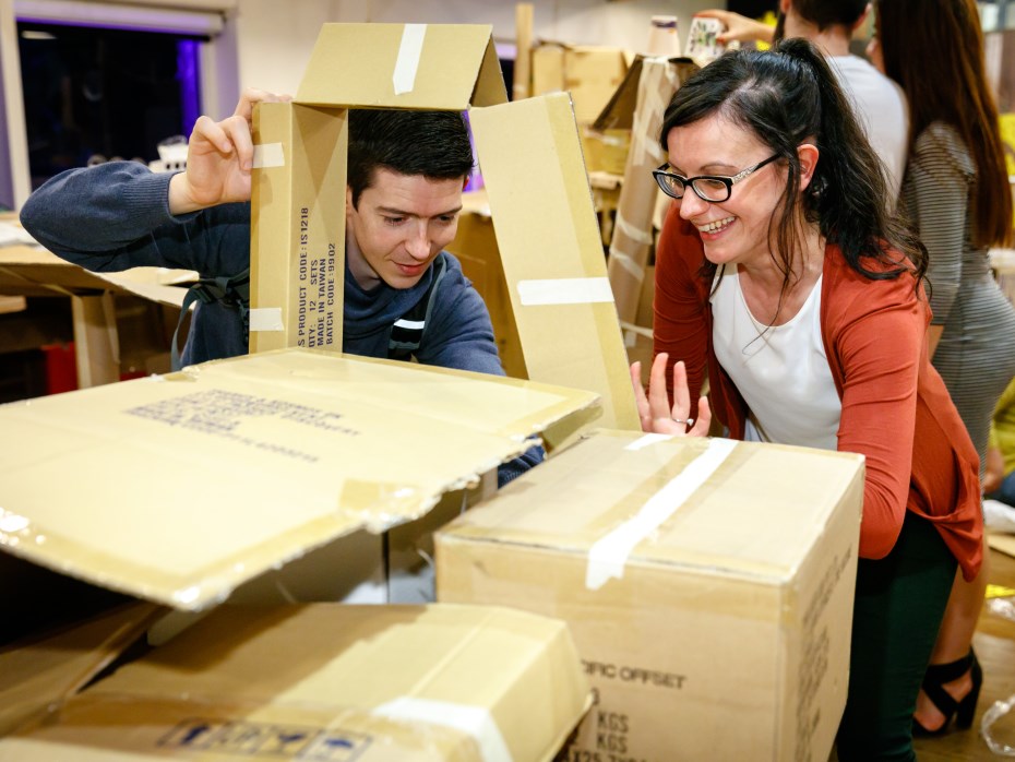 Man and Lady building a box fort and smiling