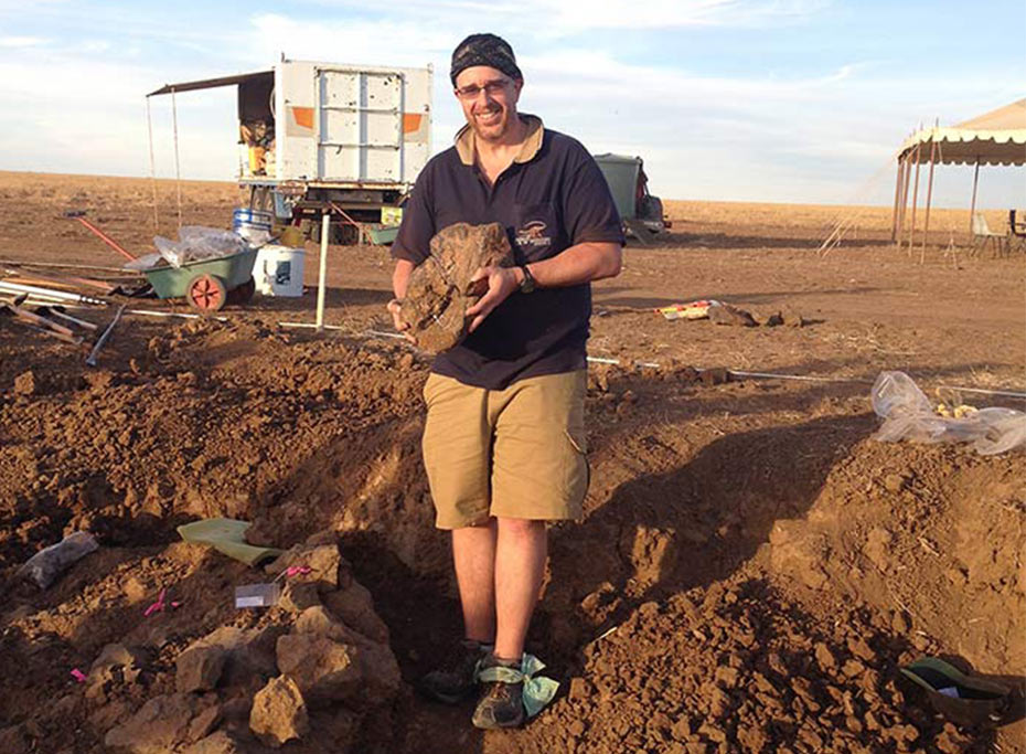 Questacon Excited Particle David Cannell holding a fossil in outback Queensland Questacon Excited Particle David Cannell holding a fossil in outback Queensland