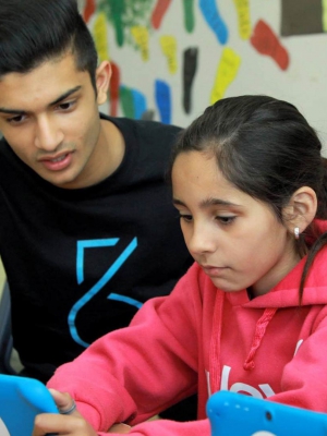 Taj Pabari and a young girl work on a Fiftysix Creations tablet