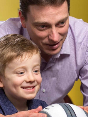 David Hobbs teaches a young boy to use Orby