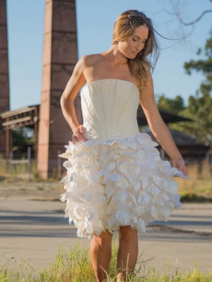 Woman wearing white dress made from an alternative beer product.