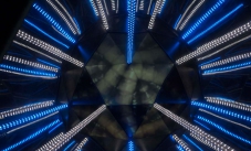 blue and white lights running into the centre mirror area, where their are reflections of worms