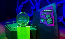A kit drum with a stainless steel handle and green support in front. To the right is a purple infomation sign with the words 'Heart Rate'