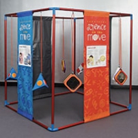 A large red and blue cube frame that has orange and blue information panels hanging from top to bottom. Inbetween these panels are blue and orange trianguular and square objects.