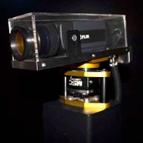 A black thermal camera enclosed in a protective perspex box