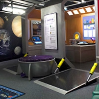 A wall painted with planets and the entrance way to a pretend space ship.