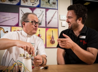 Teacher Workshop presenter talks to a teacher
