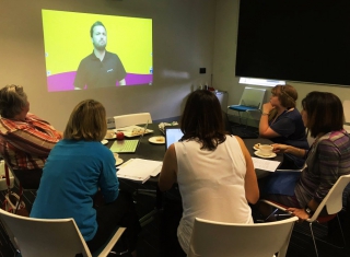 Teachers watch a Teacher Workshop presenter through video conference