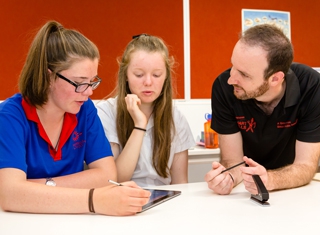 presenter and students using tablet