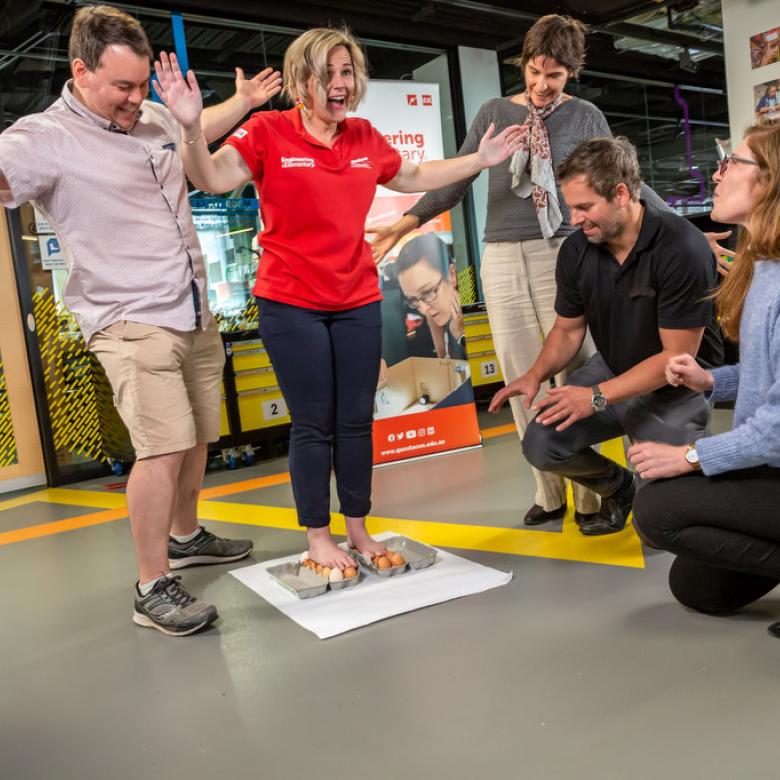 A Questacon presenter stands on eggs