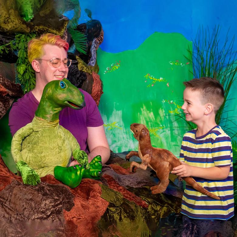 Mutty the Muttaburrasaur greeting a young boy