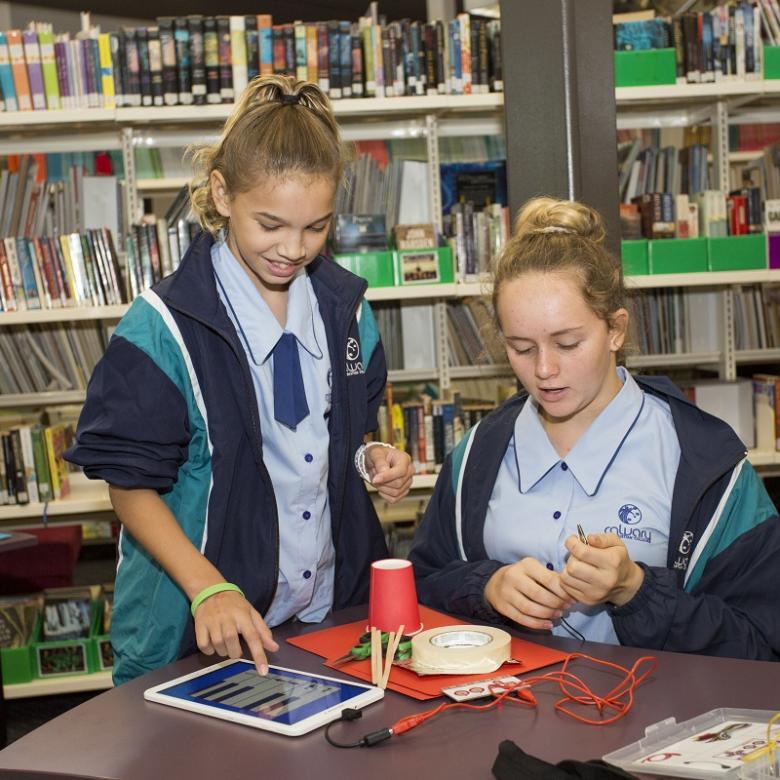 Two girls looking at an ipad