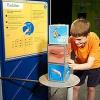 A boy looking at three cubes
