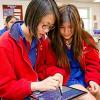 Two girls looking at a tablet computer