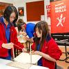 Two girls build a landing platform out of house hold materials