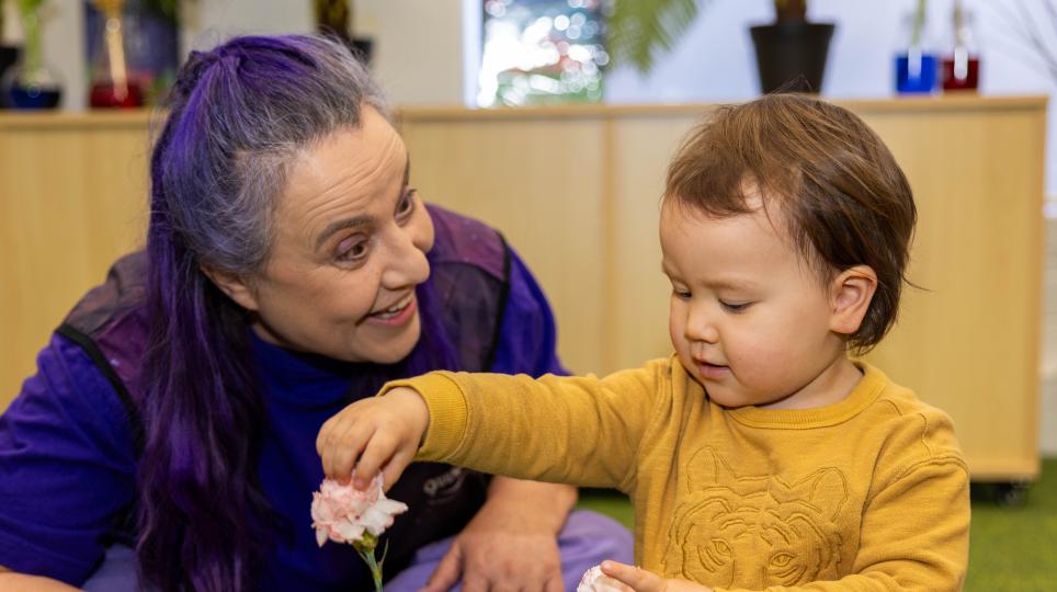 Questacon employee showing a child the science of flowers