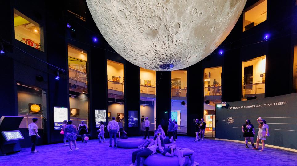 Gallery 8 at Questacon showing the Moon model and children reaching the planet information