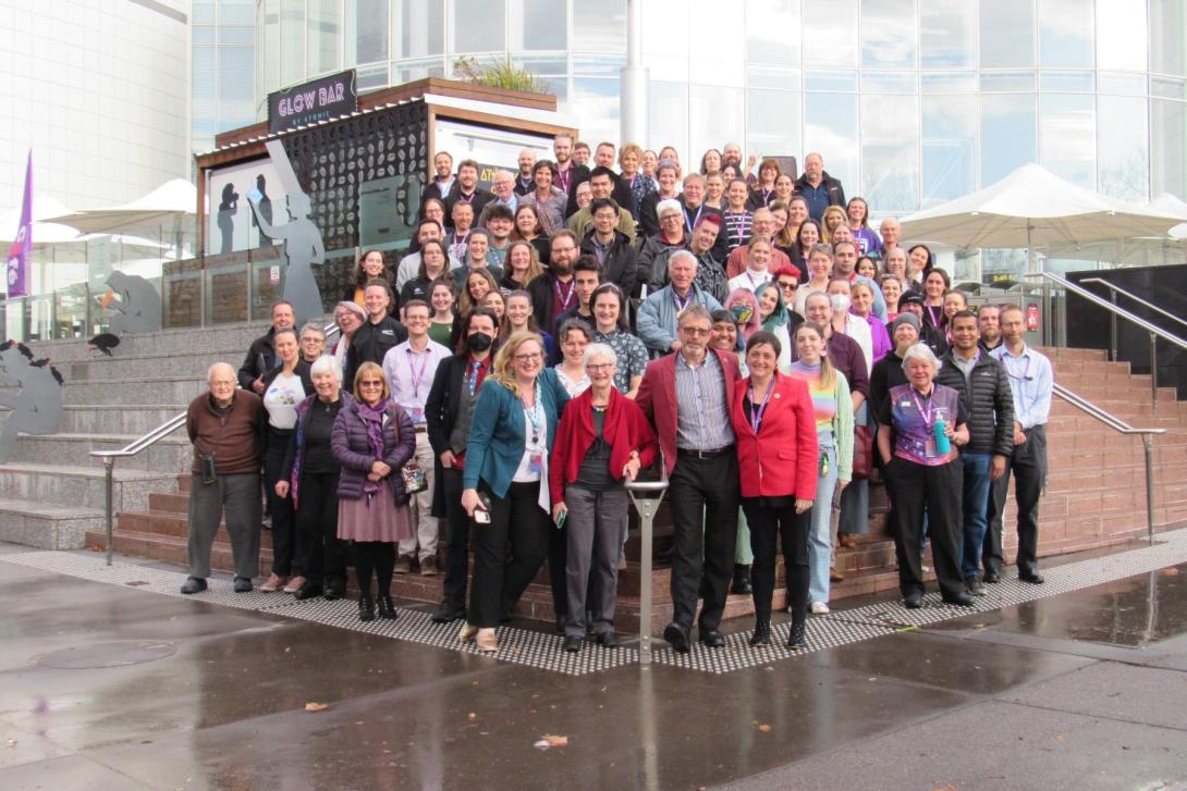 Questacon staff stand in front of the Questacon building