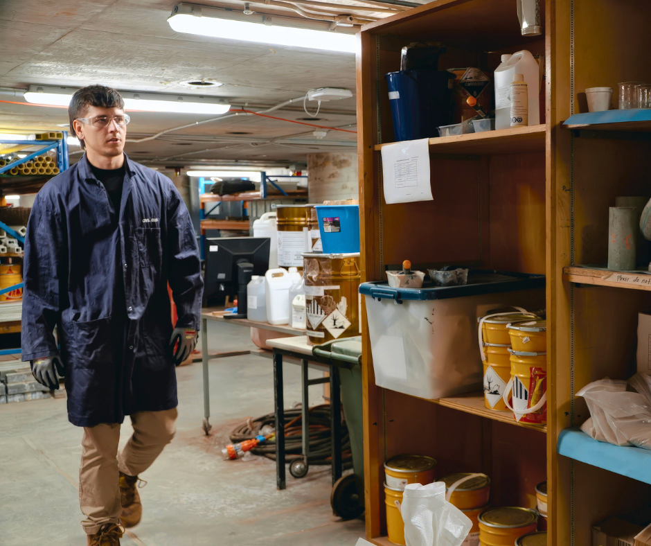 Associate Professor Shannon Kilmartin-Lynch in a room next to shelves containing scientific equipment